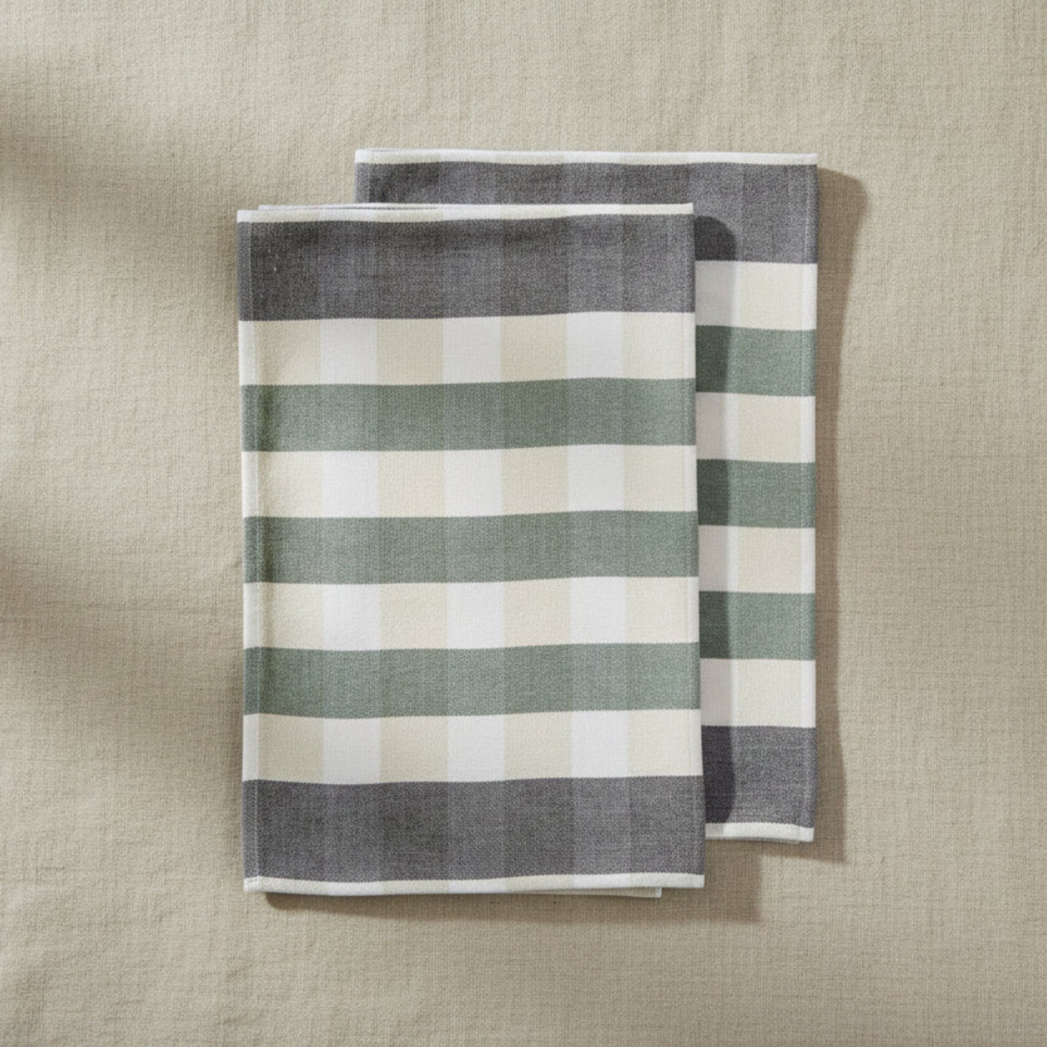 Two striped towels, one gray and white, one green and white, on a white background.