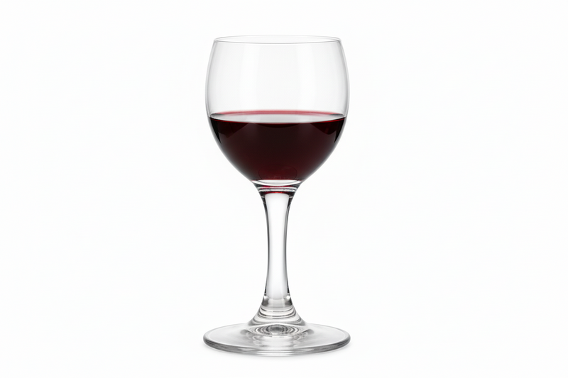 Wine glass filled with red wine on a white background