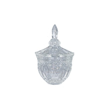 Clear glass candy dish with lid on a white background