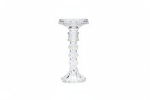 Clear glass candle holder on a white background