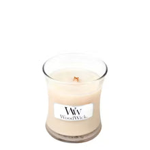 WoodWick candle in a clear glass jar on a white background